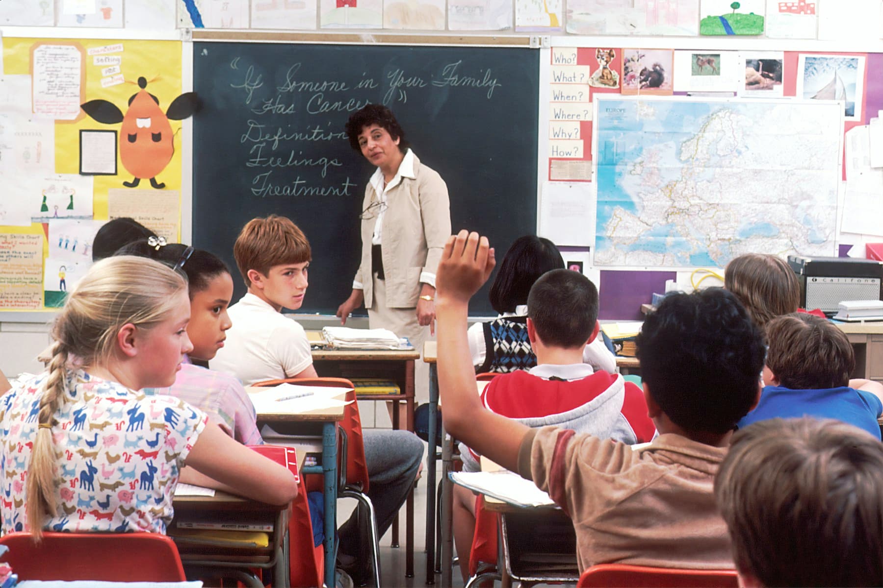 A teacher in front of a class of children